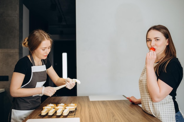 Young couple smiling happy cooking sweets at kitchen