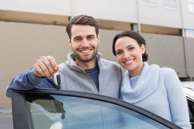 Young couple smiling holding new key