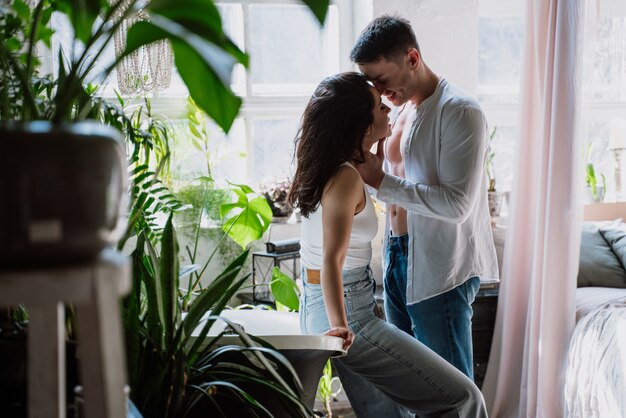 Young couple spending time in their beautiful countryside house. Romantic lifestyle moments