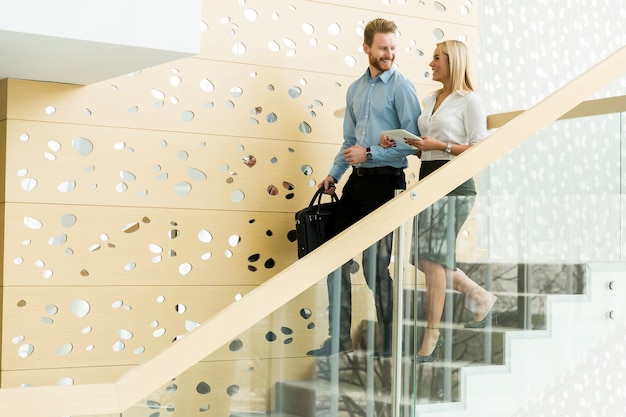 Young couple on stairs in the office