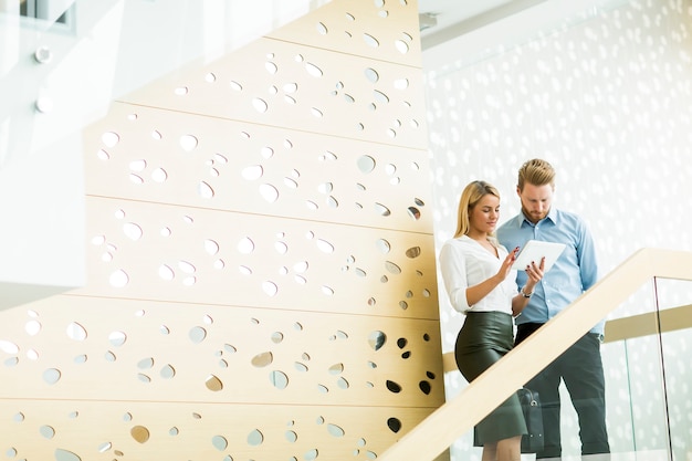 Young couple on stairs in the office