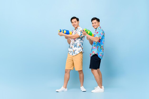 Young couple standing against blue background