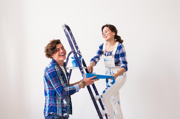 Young couple standing against white background