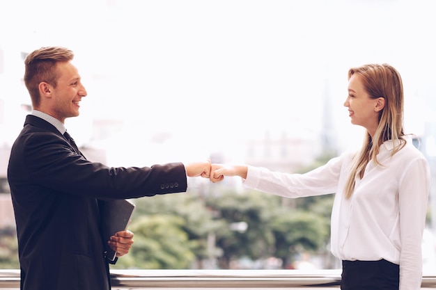 Young couple standing against white wall