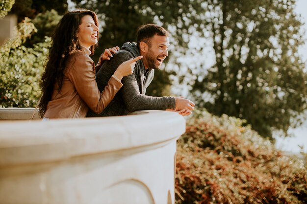 Young couple standing at the balcony on autumn day