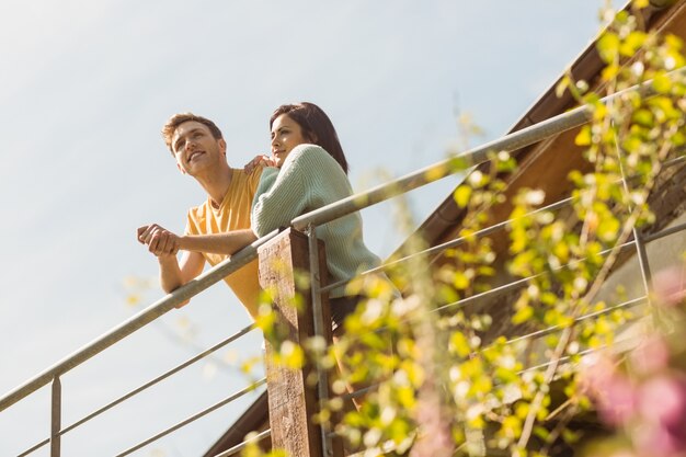 Young couple standing and looking out