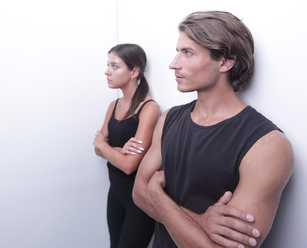 Young couple standing near the wall