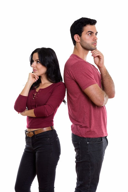 young couple standing while thinking and looking