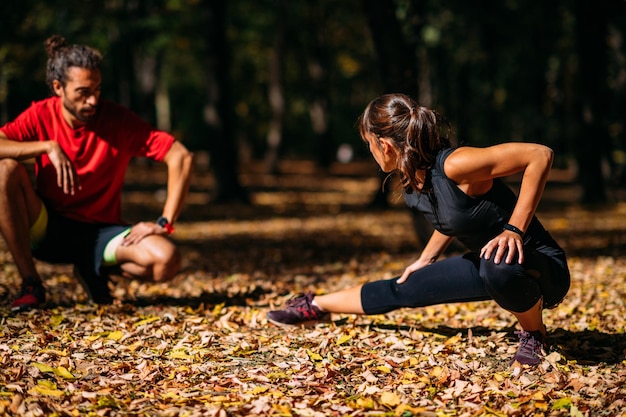 Young Couple stretching after training in the park