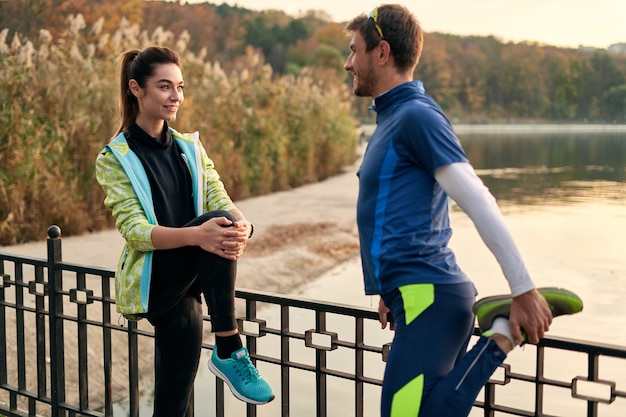 Young couple stretching before training