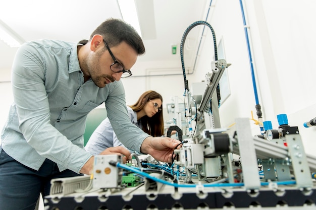 Young couple of students at robotics lab