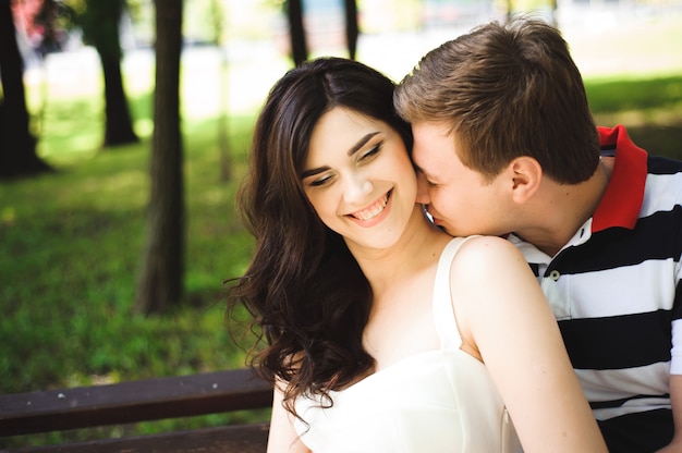 Young couple at the summer park. Outdoors.