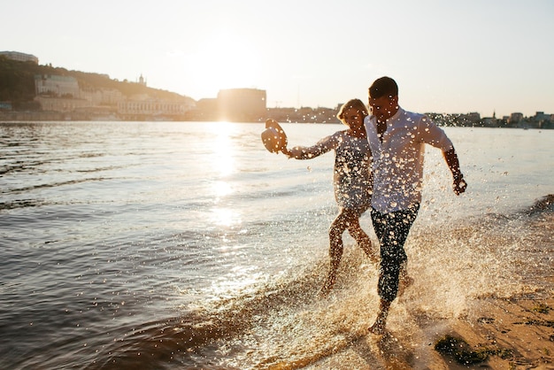 Young couple at sunset by the water