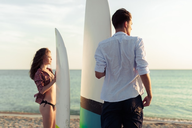 Young couple of surfers