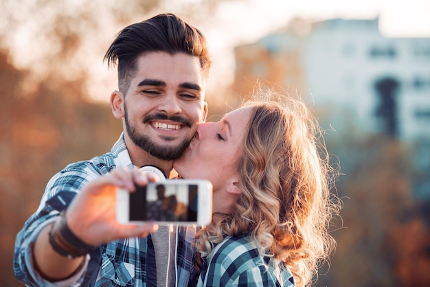  Premium Photo | Young couple taking selfie in the city