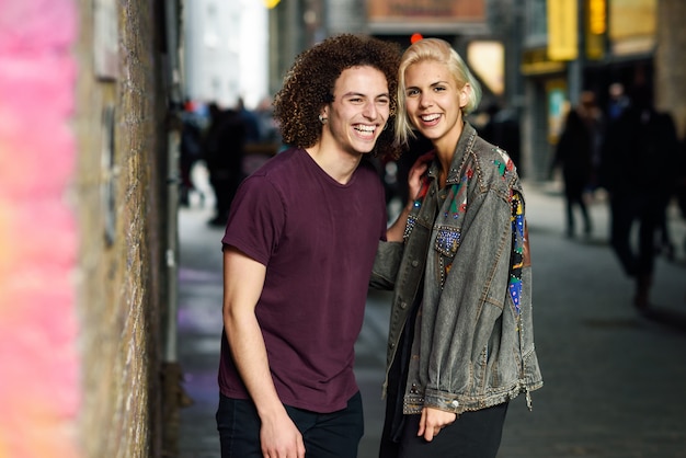 Young couple talking in urban background on a typical London street.