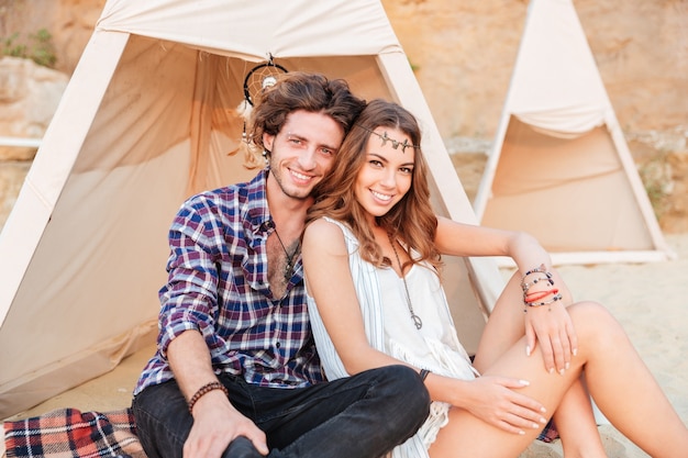 Young couple in teepee on the beach