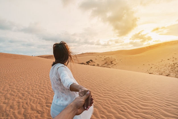 Young couple traveler at red sand dunes