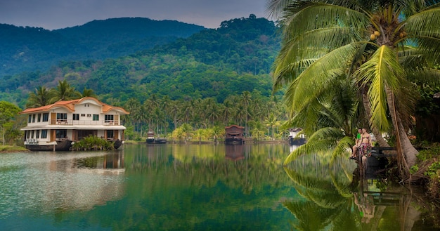 Young couple on a tropical lake pier