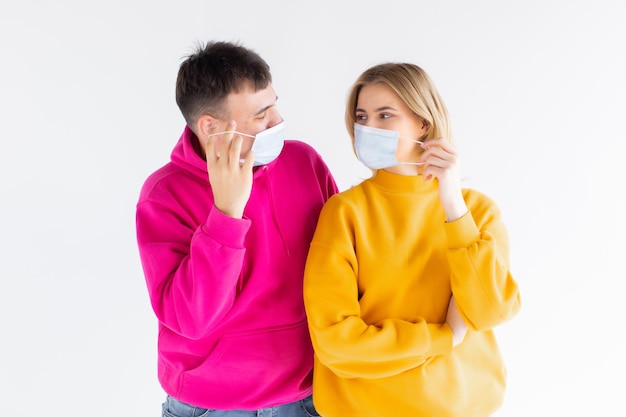 Young couple two friends man woman in white blank print design tshirts sterile face mask