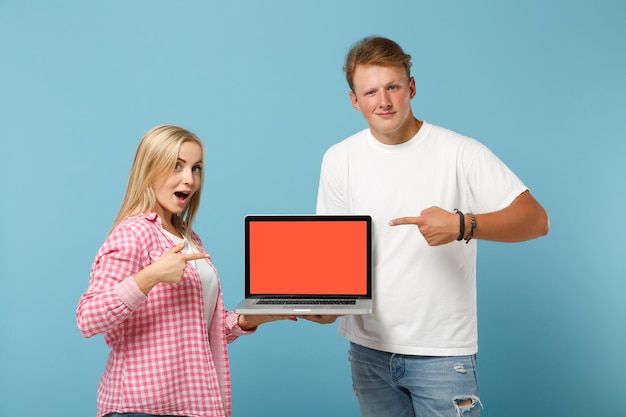 Young couple two friends man and woman  in white pink t-shirts posing 