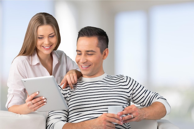 Young couple using digital tablet at home, online shopping