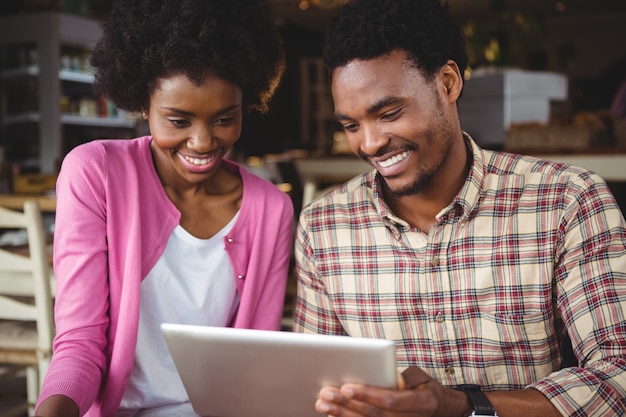 Young couple using digital tablet