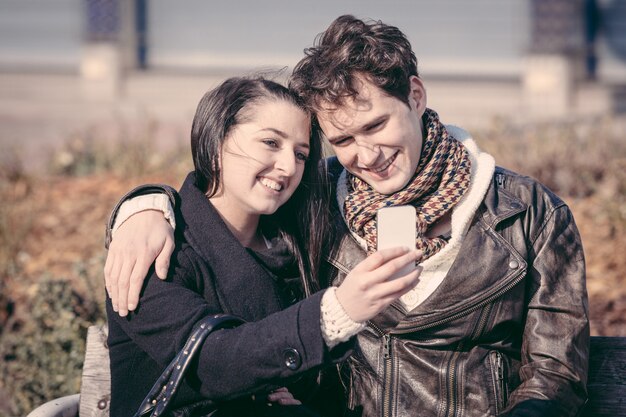 Young Couple Using Mobile Phone