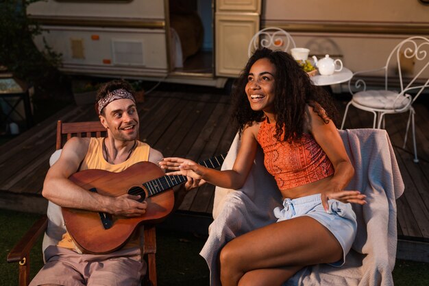 Young couple on vacation with the camper. Traveling with the autocaravan. Concept about wanderlust road trips and lifestyle on vacation