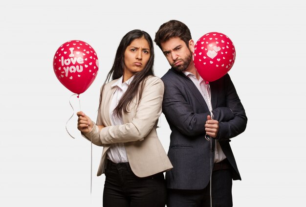 Young couple in valentines day crossing arms relaxed