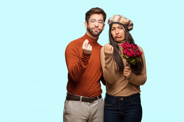 Young couple in valentines day doing a gesture of need