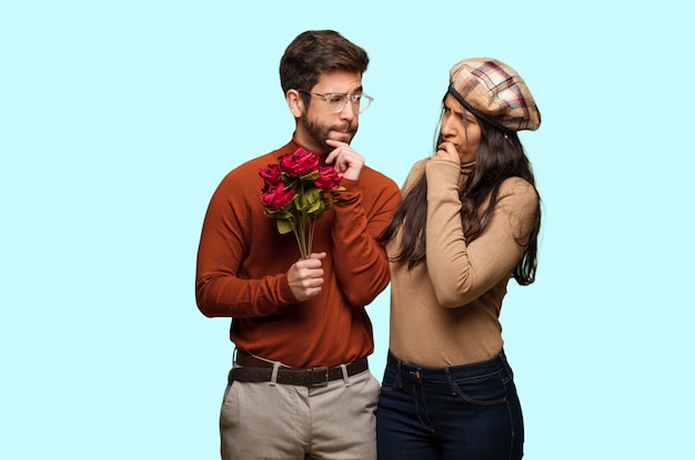 Young couple in valentines day doubting and confused