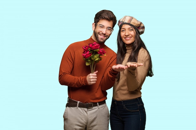 Young couple in valentines day holding something with hands