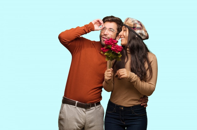 Young couple in valentines day making the gesture of a spyglass