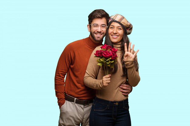 Young couple in valentines day showing number four