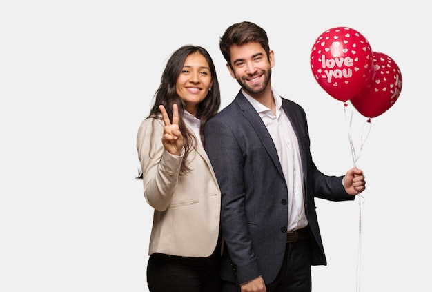 Young couple in valentines day showing number two