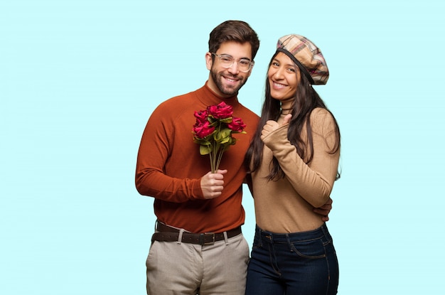 Young couple in valentines day smiling and raising thumb up