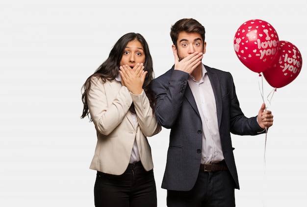 Young couple in valentines day surprised and shocked