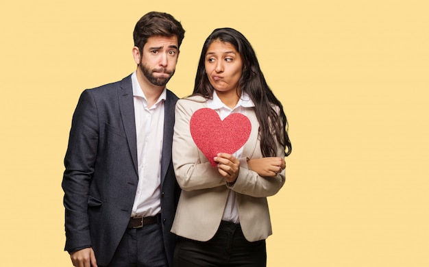 Young couple in valentines day thinking about an idea