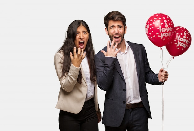 Young couple in valentines day very scared and afraid