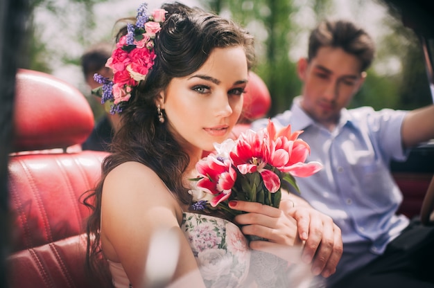 Young couple in vintage cars