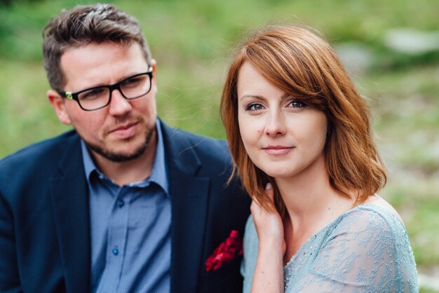 Young couple on a walk near the lake surrounded by the Carpathian mountains