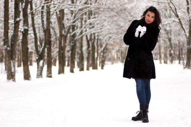 A young couple walk in a winter park