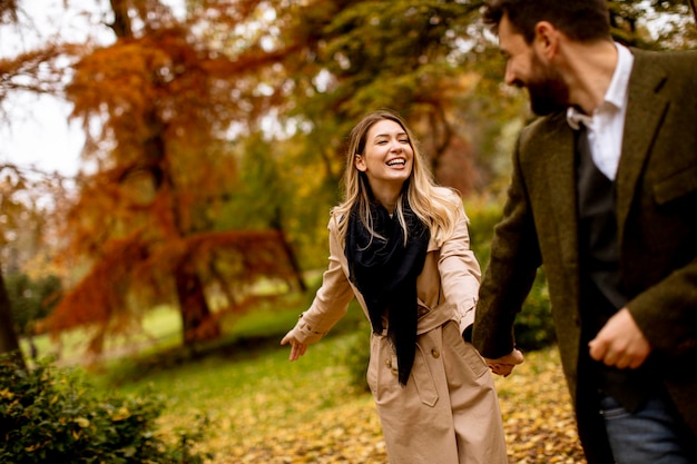 Young couple walking in the autumn park