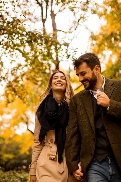 Young couple walking in the autumn park