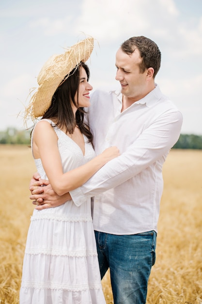 Young couple walking in a golden field