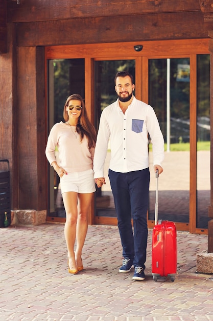 young couple walking out of hotel