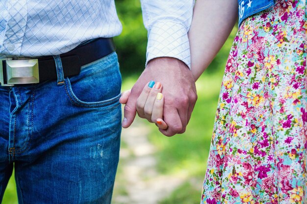 Young couple walking in the park and holding hands