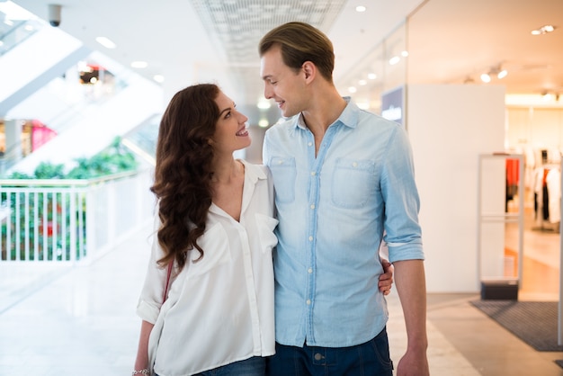 Young couple walking in a shopping mall and having fun