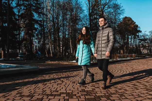 A young couple walks in the City Park of the city on the day of St. Valentine. 